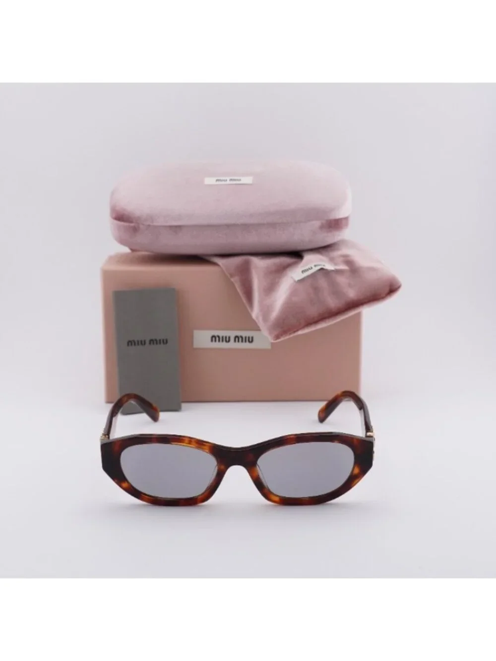 Miu Miu MUA03S 21C40O Sunglasses Havana Mahogany Oval Frame, Grey Lenses